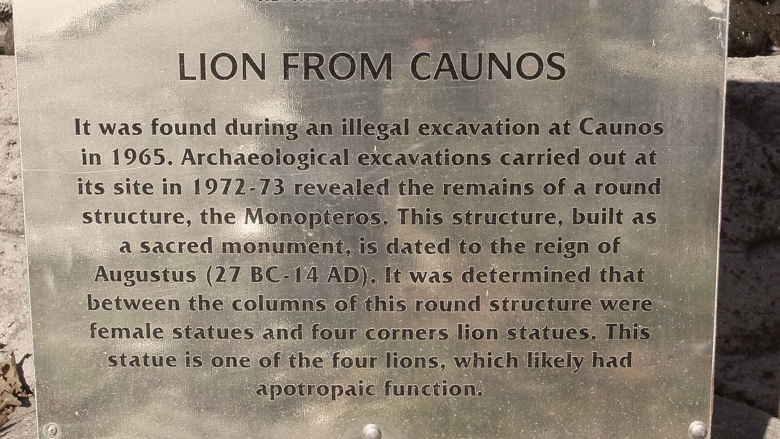 The information plaque beside the statue